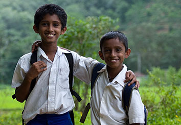 Two boys smiling by the hills